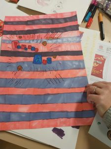 Piece of paper with red and blue stripes with red and blue squares
