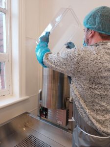 Social Enterprise Lead pouring popcorn into mixer