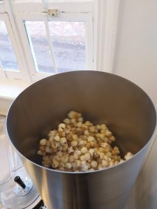 Popcorn being flavoured using the mixing machine